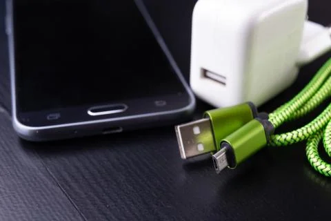 A usb cable for data transfer and phone charging. Telephone and accessories o Stock Photos