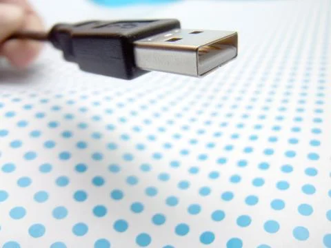 Usb cable on dotted background Stock Photos