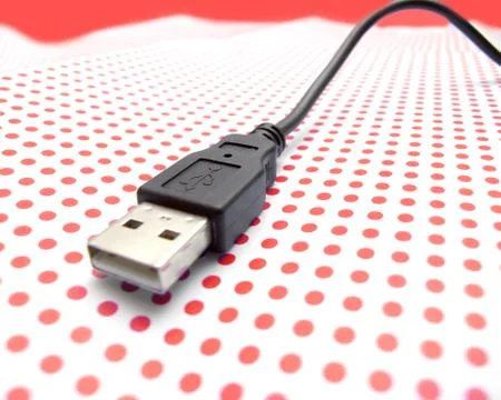 Usb cable on dotted background Stock Photos
