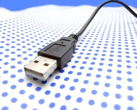 Usb cable on dotted background Stock Photos
