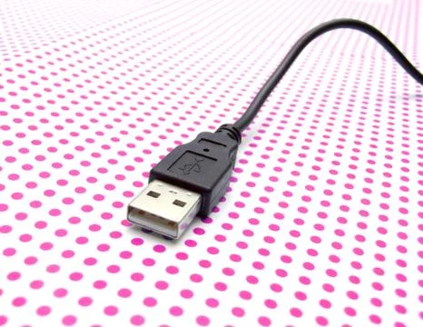 Usb cable on dotted background Stock Photos