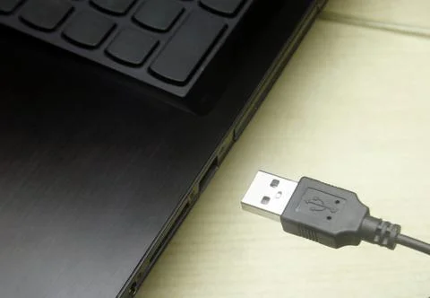 USB cable plugging in to laptop Stock Photos