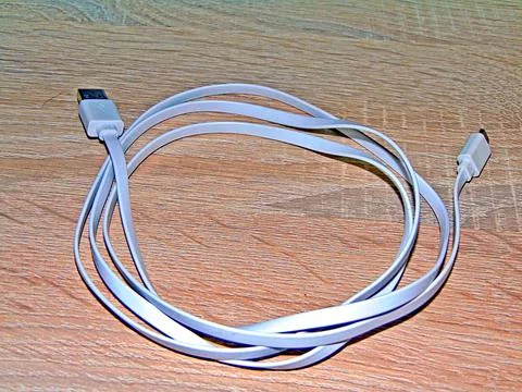 USB cable on a wooden background Photos