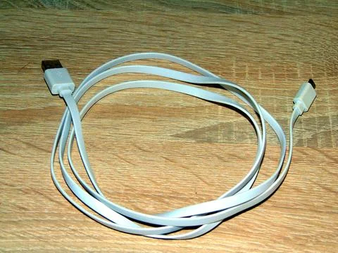 USB cable on a wooden background Photos