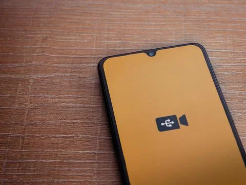 USB Camera app launch screen on smartphone on wooden background Stock Photos