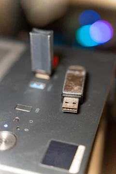 USB drive and a small memory stick placed on a computer surface at night Stock Photos