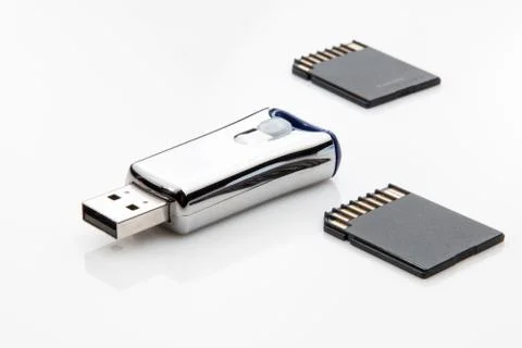 USB flash drive and two micro sd cards on white background. Stock Photos