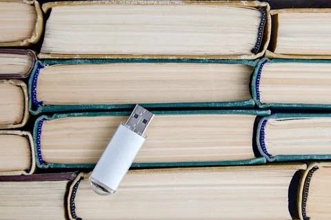 Usb flash drive on background of stack of paper books 스톡 사진