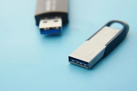 USB flash drive on blue background close up Stock Photos