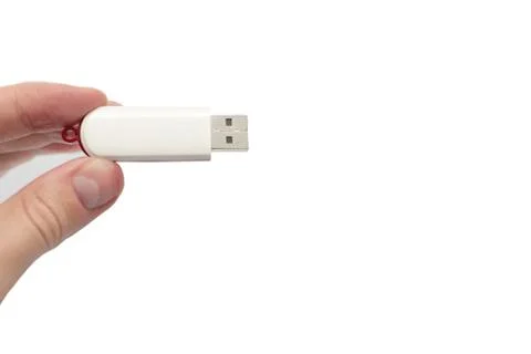 USB flash drive close up shot held between fingers by Caucasian male hand iso Stock Photos