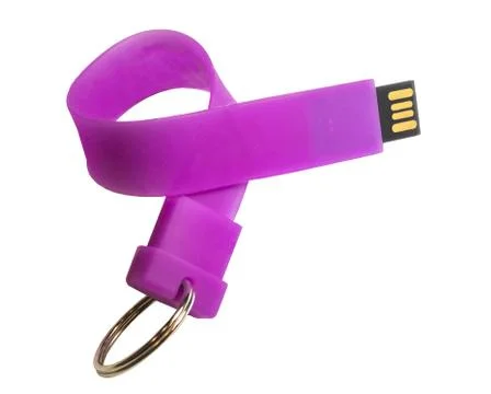 Usb Flash Drive in the form of a flexible silicone band keychain with a key r Stock Photos