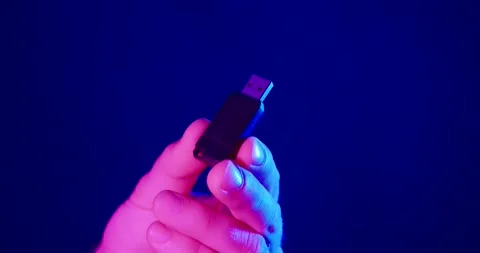 USB Flash Drive in Hand Under Neon Light Close Up Stock Footage 342345056
