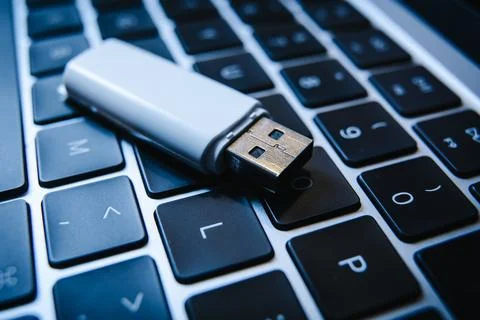 USB flash drive lying on a laptop keyboard as a concept of cyber security and 库存照片