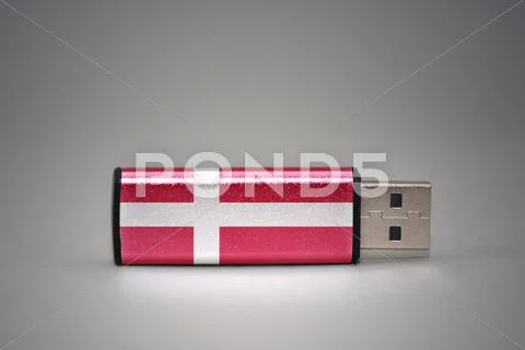 Usb flash drive with the national flag of denmark on gray background. Stock Photos