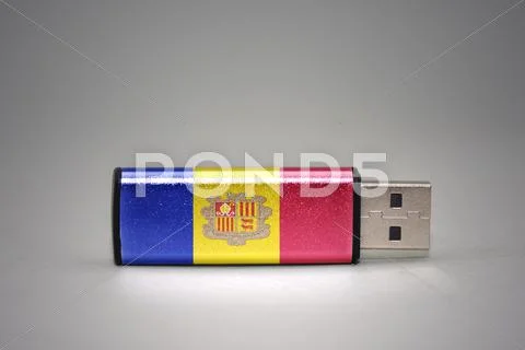 Usb flash drive with the national flag of andorra on gray background. Stock Photos