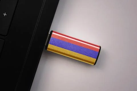 Usb flash drive in notebook computer with the national flag of armenia on g.. Stock Photos