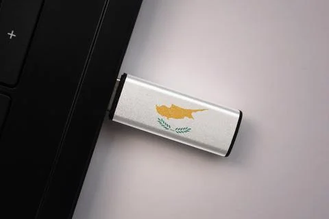 Usb flash drive in notebook computer with the national flag of cyprus on gr.. Stock Photos
