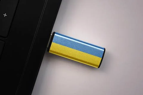 Usb flash drive in notebook computer with the national flag of ukraine on g.. Stock Photos