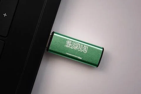 Usb flash drive in notebook computer with the national flag of saudi arabia.. Stock Photos