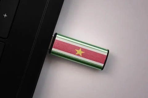 Usb flash drive in notebook computer with the national flag of suriname on .. Stock Photos