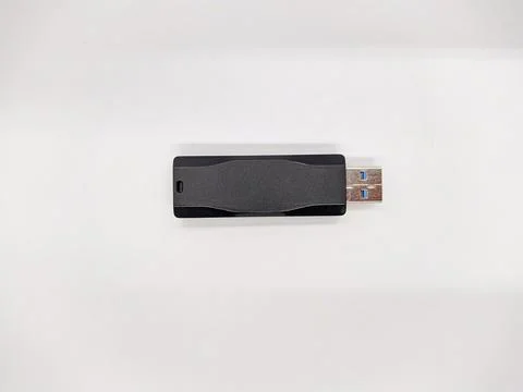 USB flash drive. one black USB flash drive on a white background top view Stock Photos