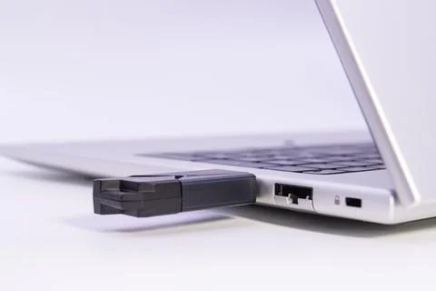 USB flash drive plugged into laptop usb port showing external storage Stock Photos