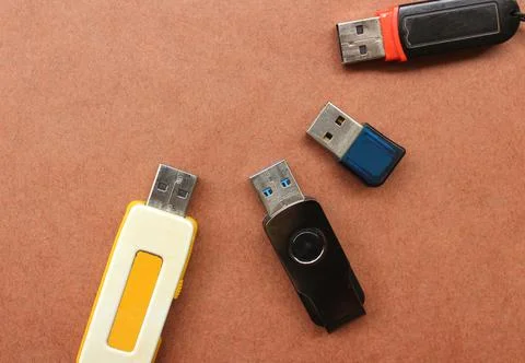 USB flash drives on brown background Stock Photos