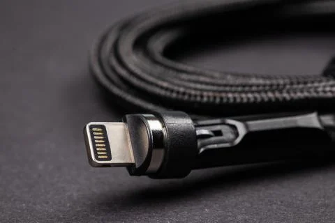 Usb lightning white data cable on dark background Stock Photos