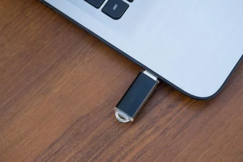 USB memory stick or flash drive attached to the side of a laptop computer Stock Photos