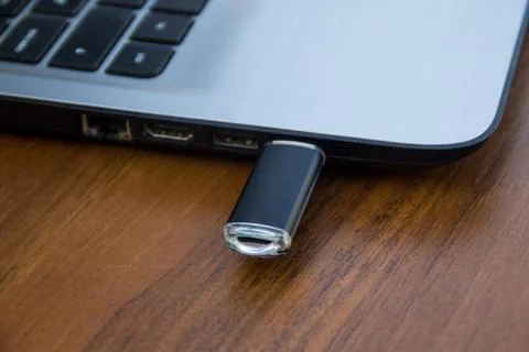 USB memory stick or flash drive attached to the side of a laptop computer Stock Photos