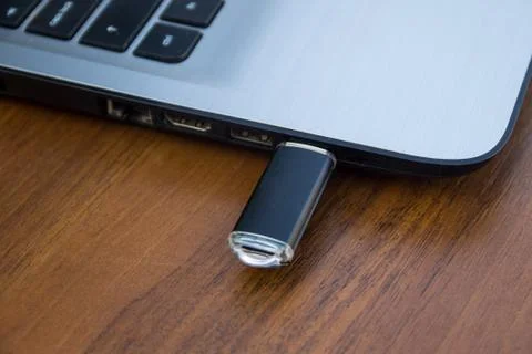 USB memory stick or flash drive attached to the side of a laptop computer Stock Photos