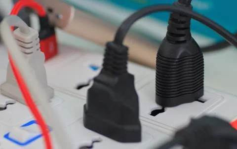 Usb plug among electrical plugs socket for multiple port chargers. Stock Photos
