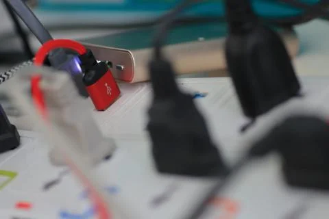Usb plug among electrical plugs socket for multiple port chargers. Foto stock