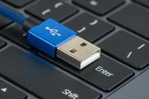 Usb with plug cable on button enter of laptop keyboard 스톡 사진