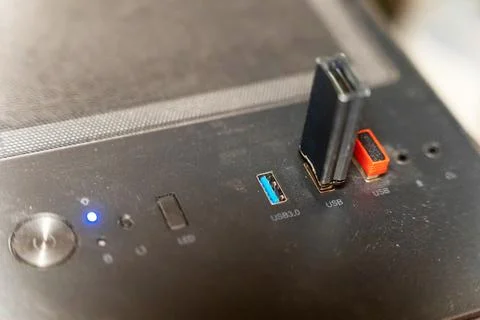 USB ports on a computer case with lights and connectors visible while in use Stock Photos