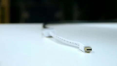 USB power cord for charging an Apple company lies on a white table Stock Footage 81756902