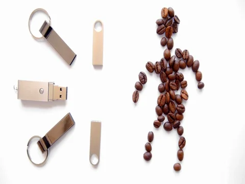 USB stick and coffee beans in human form on a white background. dolly shot Stock Footage 73854427