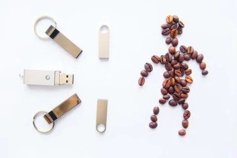 USB stick and coffee beans in human form on a white background Фото