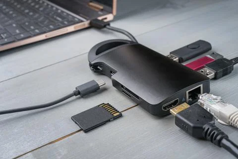 USB Type C adapter or hub connected to the laptop. Stock Photos