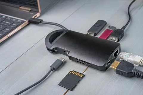 USB Type C adapter or hub connected to the laptop. Stock Photos