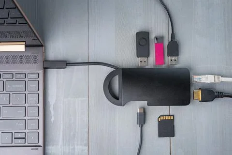 USB Type C adapter or hub connected to the laptop. Stock Photos