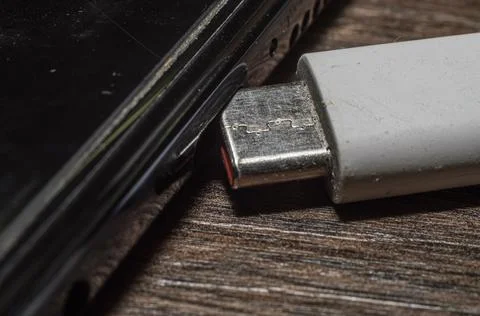 USB Type-C charging cable connects to the phone, macro shooting Stock Photos