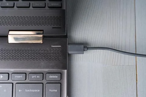 USB Type C grey cable connected to the laptop computer. Stock Photos