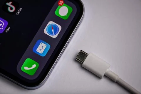 USB type C port cable for charging to the smartphone on blue background.Moldova Stock Photos
