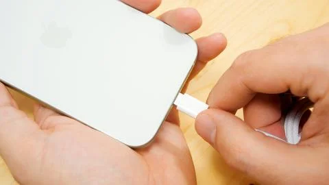 USB type-C port cable for charging apple iphone 15 green. EU law to force USB-C Stock Photos