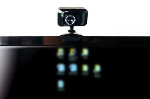USB Webcam, Web Camera, Mounted on Computer Monitor with Blurred Icons Stock Photos
