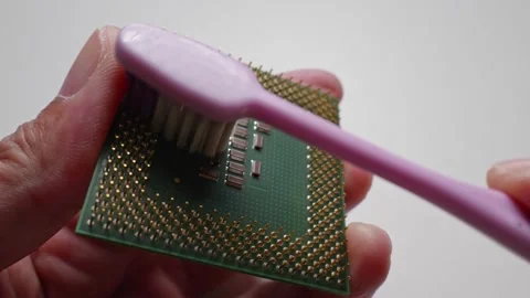 Use a brush to clean the cpu legs to clean and help fix problems from using i Stock Footage 188426391