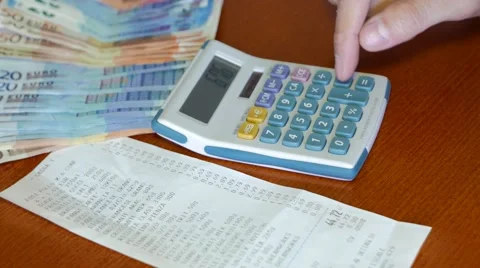 Use calculator to check receipt spending Stock Footage 61951375