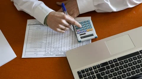 Use the calculator to count in the office Stock Footage 60697436