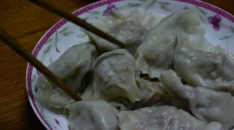 Use chopsticks eating dumplings,tradition chinese new year delicious food. Stock Footage
